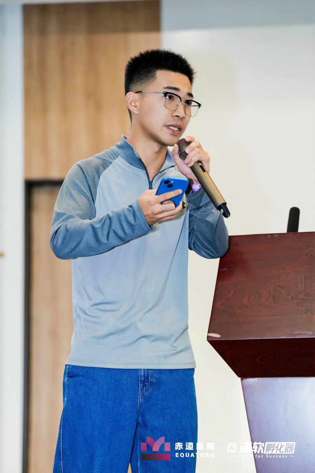 Close-up of a talk with microphone and phone in hand